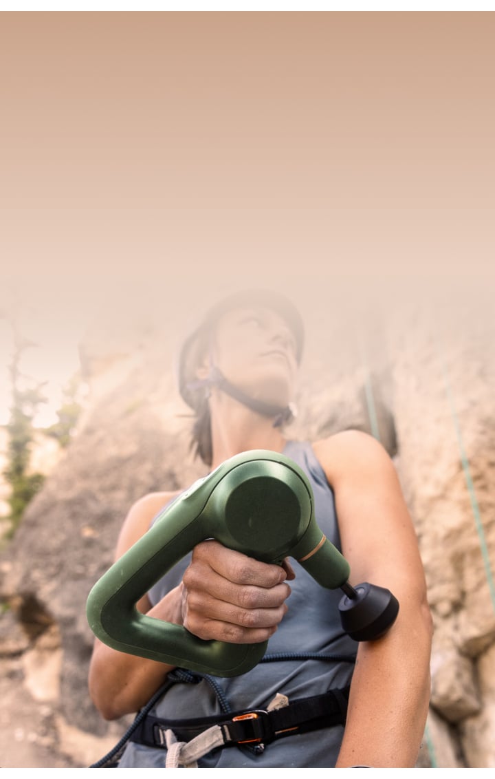 Woman using theragun prime device on arm